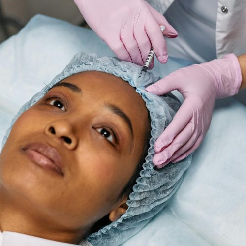 pexels-photo-7581583-7581583 Dermatologist Injecting Botox on Client's Forehead